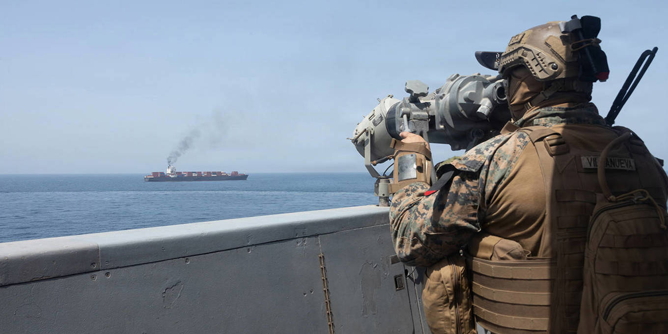US navy looks at an oil tanker near the Strait of Hormuz.