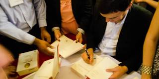 Thomas Piketty signing autographed copies of his bestseller.