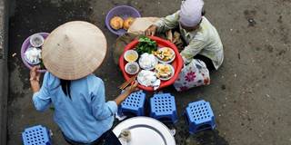 A street vendor serves up a traditional dish of fried tofu and fresh rice in Vietnam