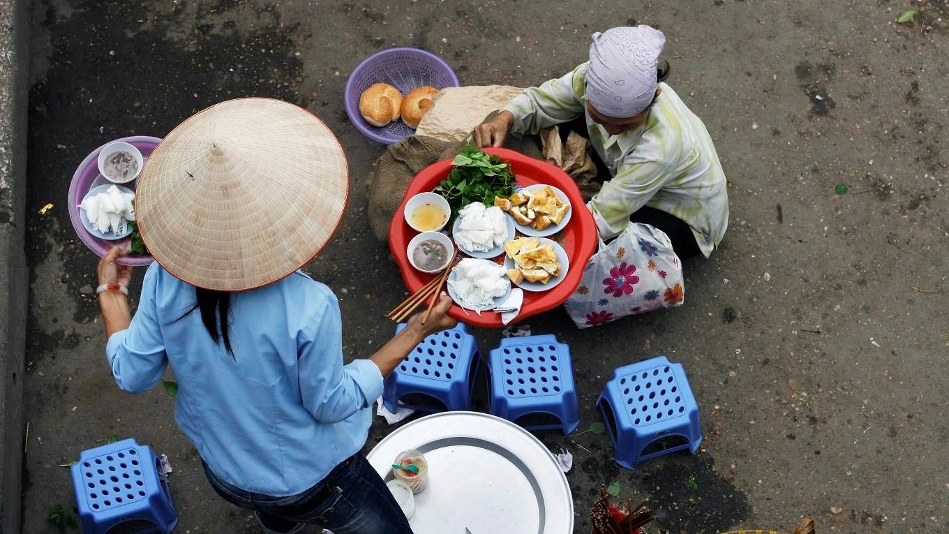A street vendor serves up a traditional dish of fried tofu and fresh rice in Vietnam