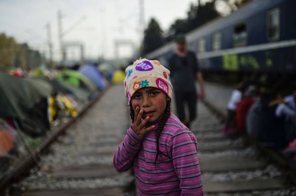 Refugee girl on train tracks