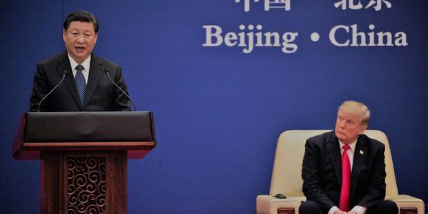 China's President Xi Jinping speaks next to US President Donald Trump