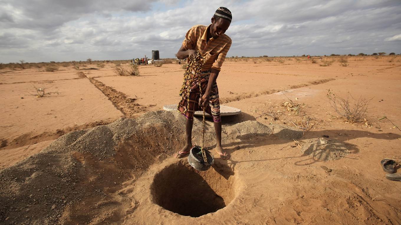 A Somalian refugee helps to dig a latrine on the outskirts of the IFO refugee camp