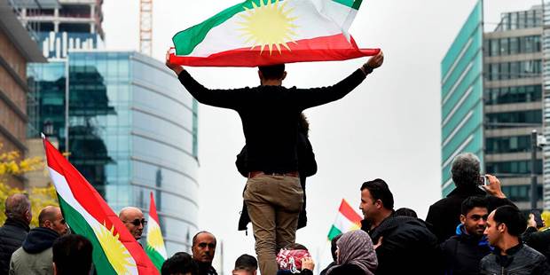 A man holds a Kurdistan's flags as he takes part in a demonstration