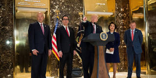  Donald Trump standing alongside Gary Cohn, Steve Mnuchin, Elaine Chao and  Mick Mulvaney