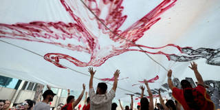 Protesters in Tirana hold a giant flamingo flag during a demonstration outside Albania&rsquo;s prime minister&rsquo;s office.