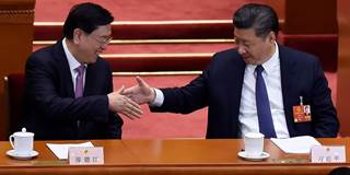  China's President Xi Jinping shakes hands with National People's Congress Chairman Zhang Dejiang 
