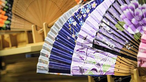 Chinese art on collapsible paper fans.