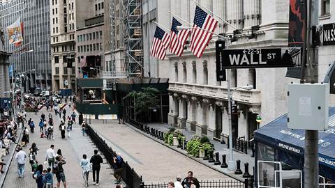 People walk past the NYSE