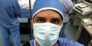 Surgeon in surgical mask.