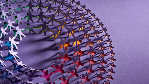 Illustration of paper people holding hands in a circle.