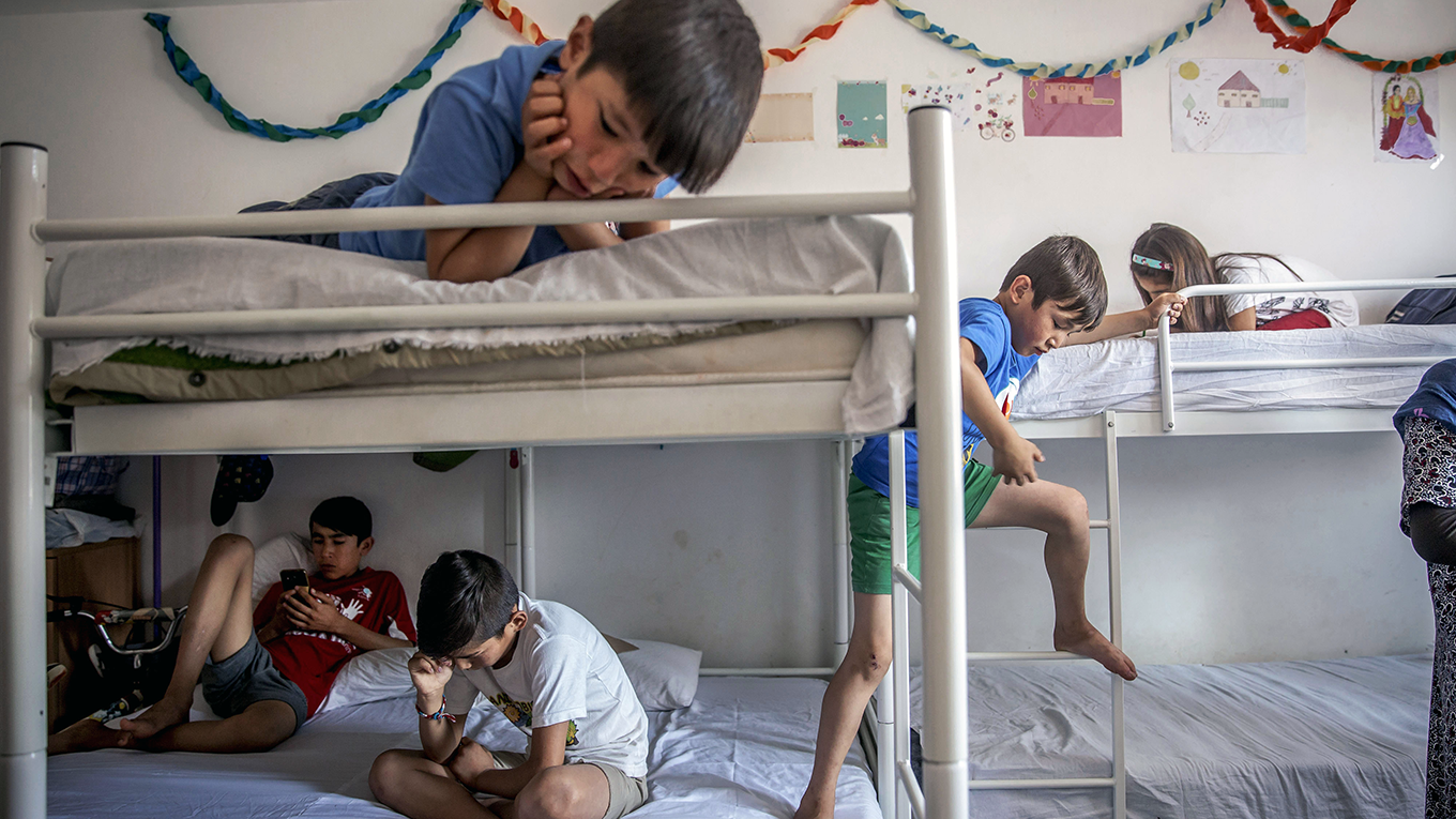 Children play in their room at a refugee camp near Belgrade