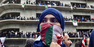 moisi168_RYAD KRAMDIAFPGetty Images_algeriaprotestwomanflag